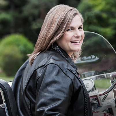 woman looking back smiling on bike